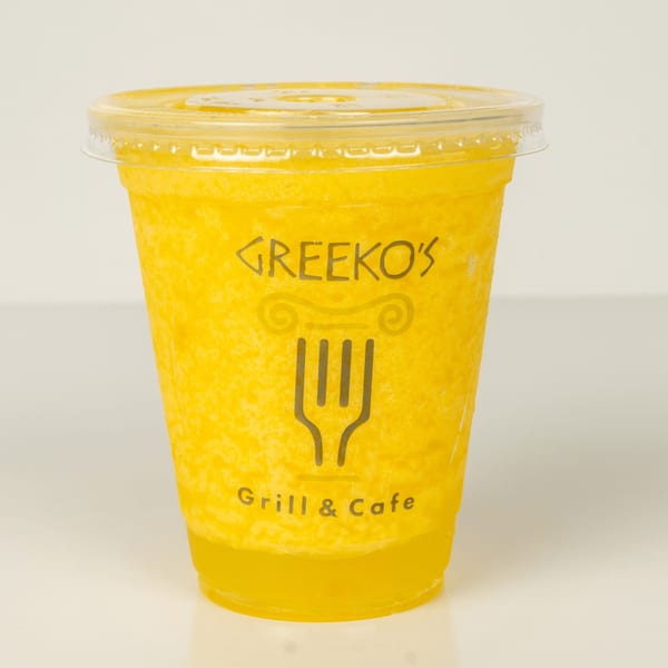 A vibrant yellow Greekos Grill & Cafe smoothie in a clear plastic cup with a lid.