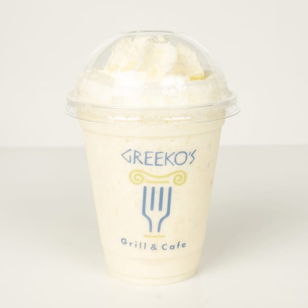 A Greekos Grill & Cafe frappe with whipped cream in a clear plastic cup.